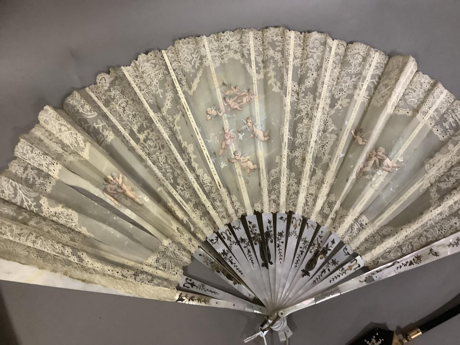 Fans: one late 19th century with gilded mother of pearl monture and painted gauze leaf; a smaller - Image 3 of 5