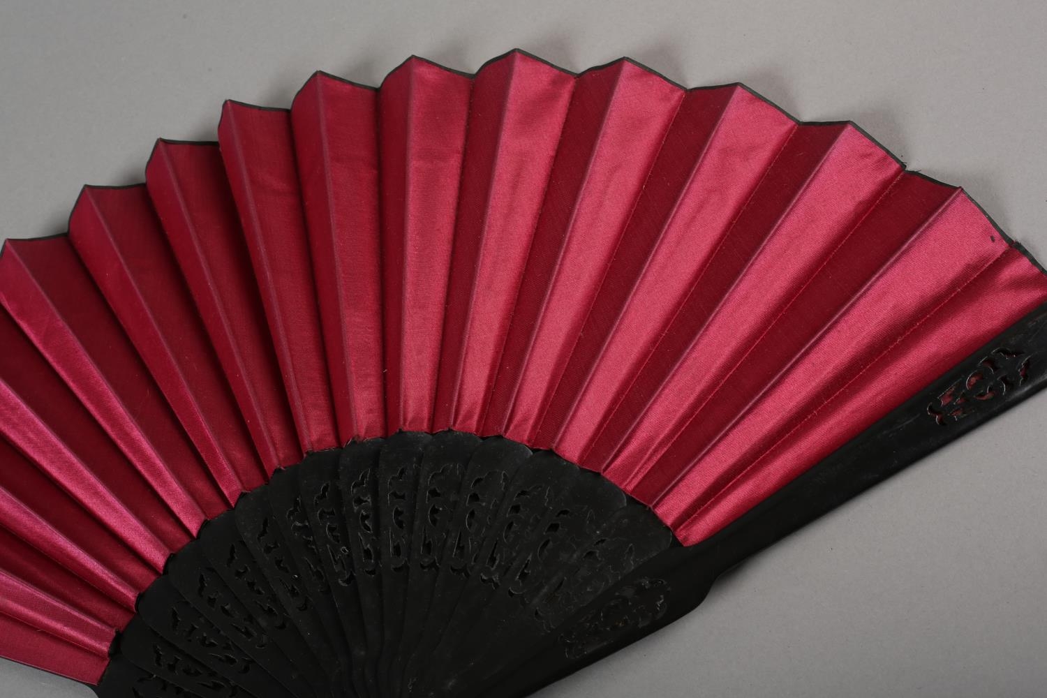 Three late 19th century fans, all with wood montures, with decorative gilding, the cerise silk leaf, - Image 5 of 6