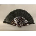 A tortoiseshell fan, c 1880’s with good mottling, mounted with a black handmade lace leaf, the