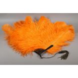 1920’s vibrant orange ostrich feather fan, large and showy, the monture of tortoiseshell, frothy