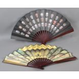 Two large, good quality, folding fans, both printed on silk, on wood montures, one showing buildings