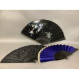 Three large late 19th century evening fans, all mounted on pierced or carved wood, the first with
