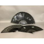 A last quarter 19th century black machine lace fan mounted on sturdy tortoiseshell sticks and