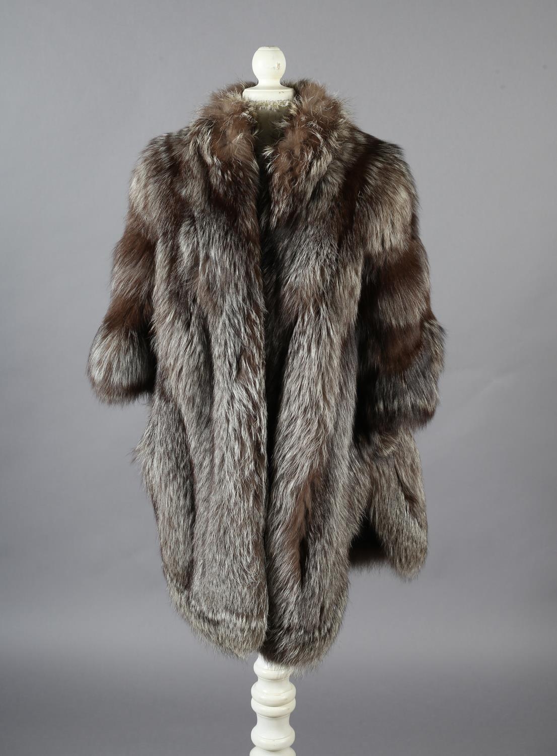 Silver fox: a three- quarter length silver fox jacket in cape form, the front and back dipping in