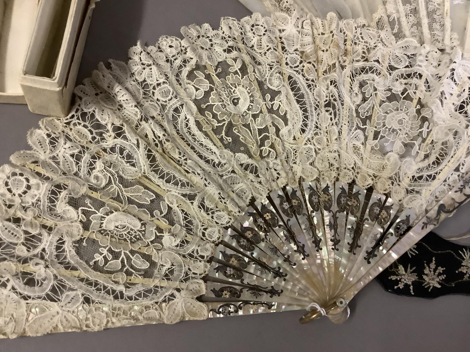 Fans: one late 19th century with gilded mother of pearl monture and painted gauze leaf; a smaller - Image 2 of 5