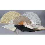 Seven late 19th century fans of large size, the first with wood monture painted gold, and