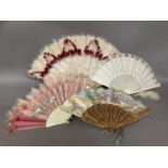 Four fans, mid-19th century onwards, to include a pierced wood example, the lithographed leaf