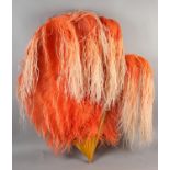 A Waterfall fan, salmon ostrich feathers with knotted extensions, in a lighter shade, mounted on