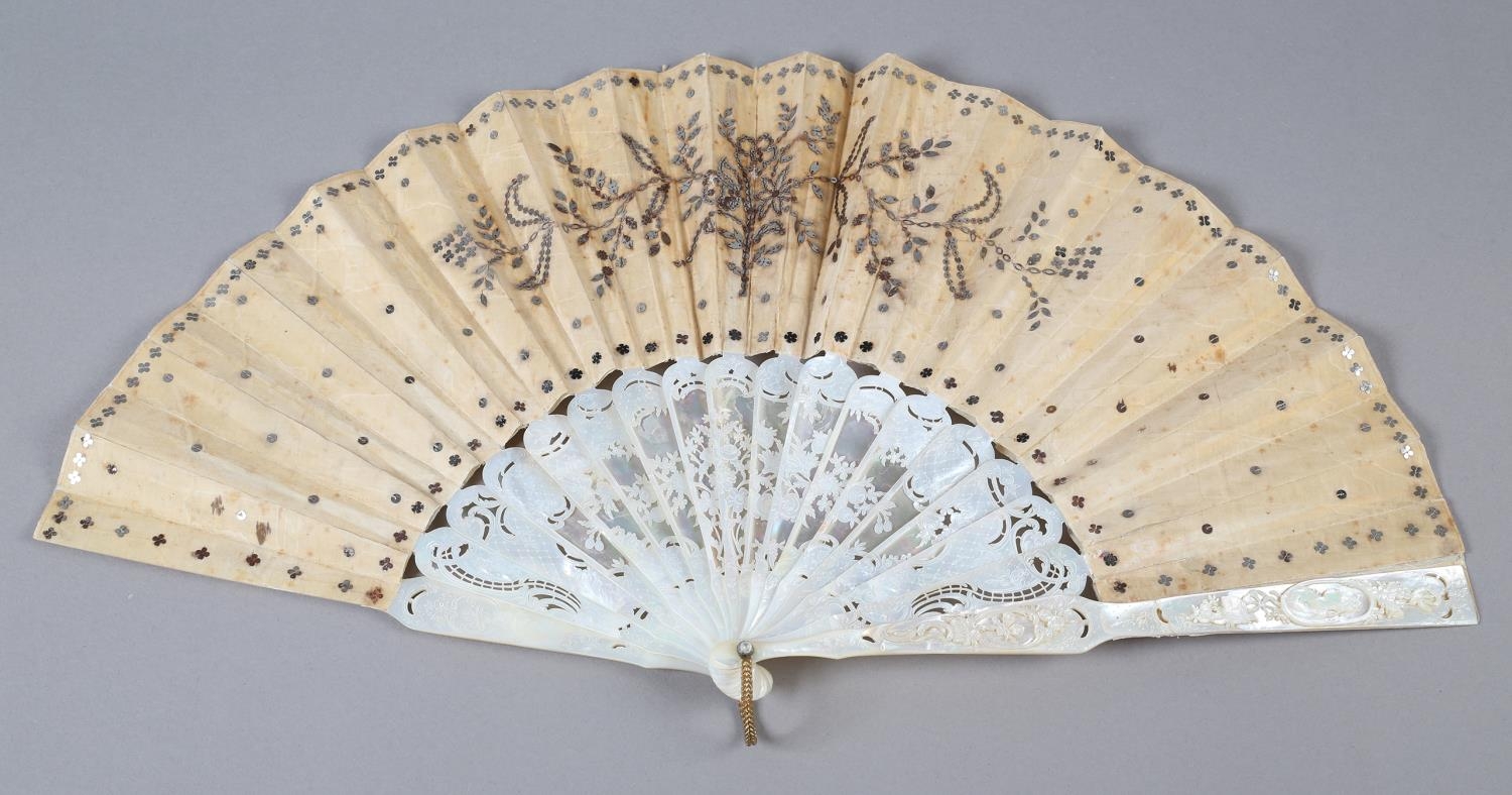 A c.1880’s mother of pearl fan with very elaborate carving, the guards pierced then applied with