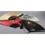 Four large late 19th century fans, all with wood montures, three with a fabric leaf, one of paper,