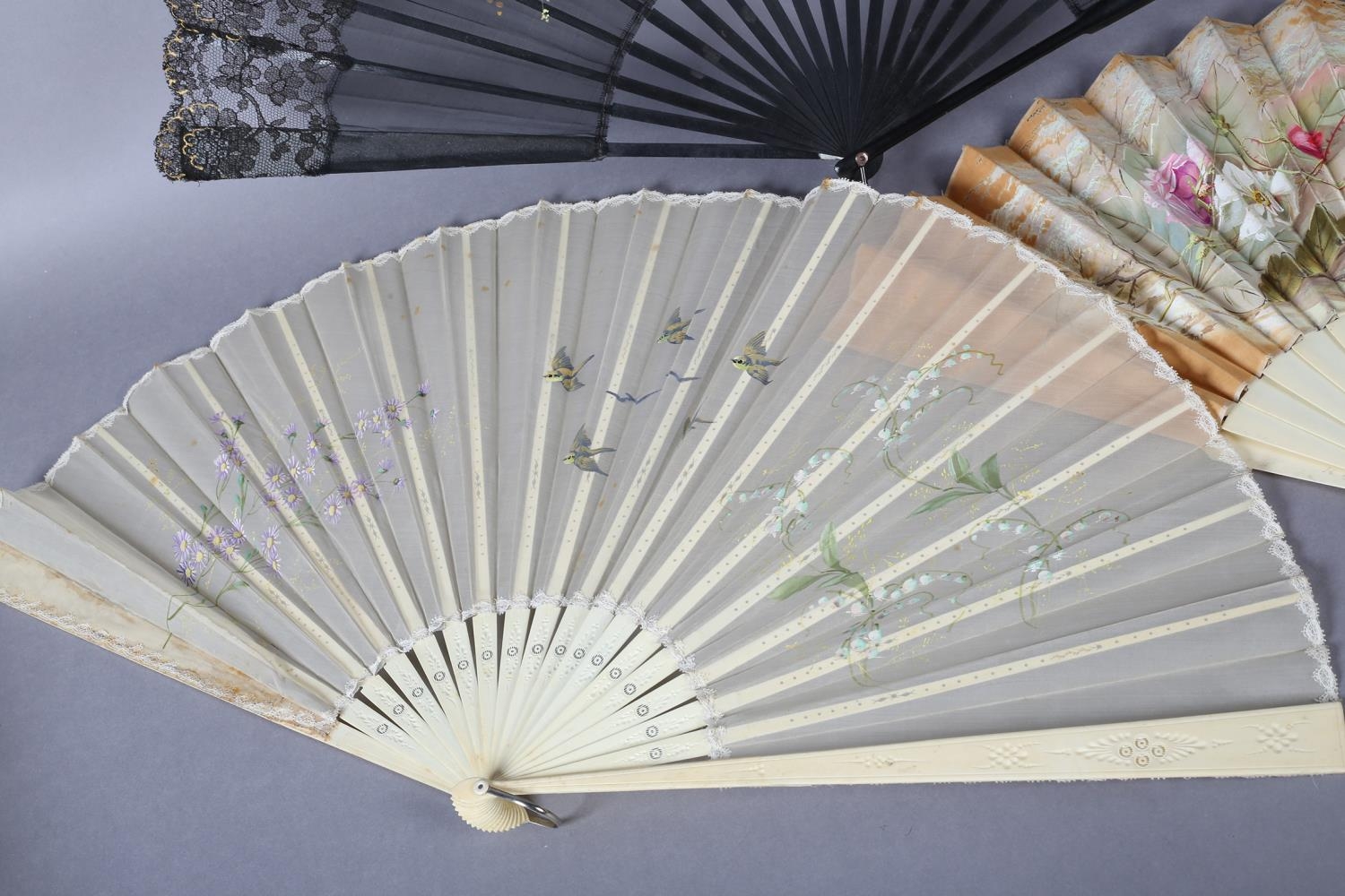 Three large fans from the 1890’s, the first painted on biscuit-coloured cotton with delicate roses - Image 2 of 4