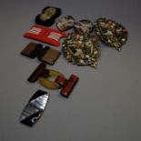 Belt buckles, early 20th century, in plastic or metal, varying colours, one example in black and
