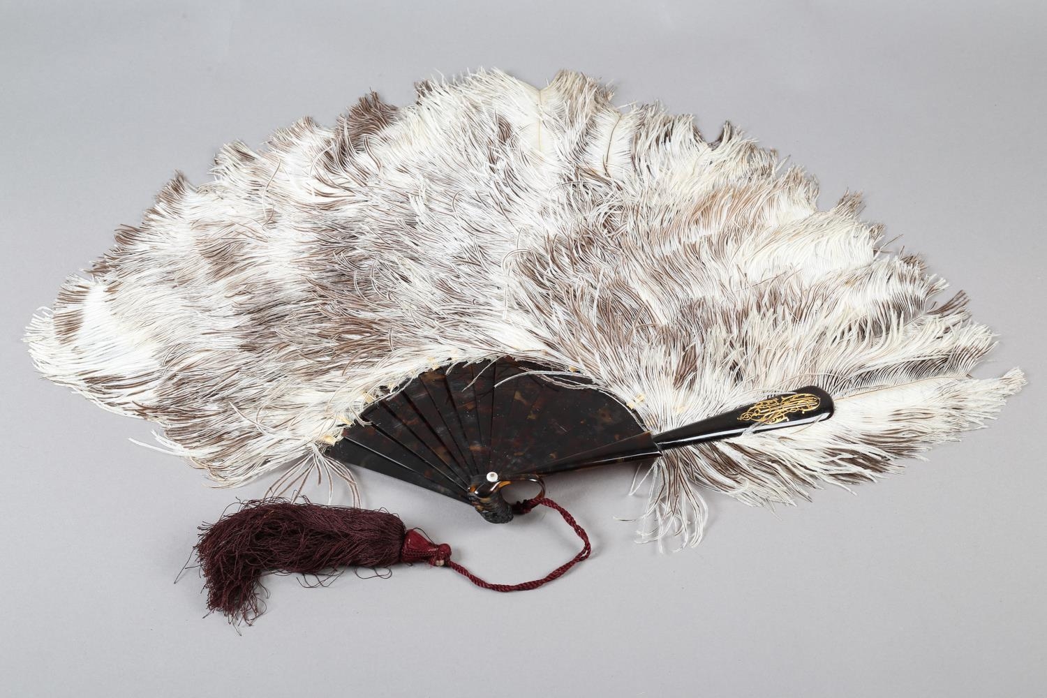 A Duvelleroy female ostrich feather fan, mounted on tortoiseshell, marked “Duvelleroy” in gold on