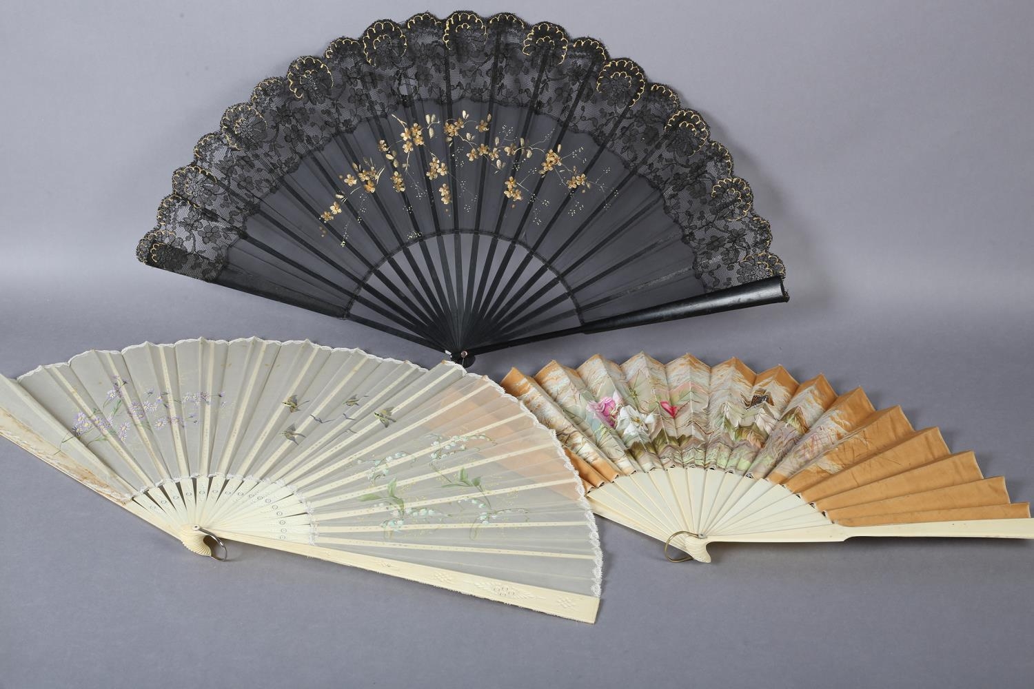 Three large fans from the 1890’s, the first painted on biscuit-coloured cotton with delicate roses