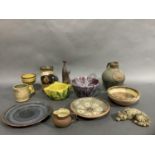 A collection of studio pottery including a blue and raspberry glazed vase, stem cup, flagon,