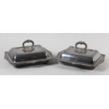 A PAIR OF EARLY 20TH CENTURY SILVER PLATED ENTREE DISHES AND COVERS, rectangular with gadroon and