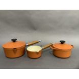 Cast iron cookware by Chasseur Invicta of orange enamel including a lidded saucepan, a small