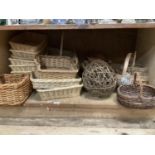 A collection of baskets including eight wicker tray type baskets, a square two handled basket,