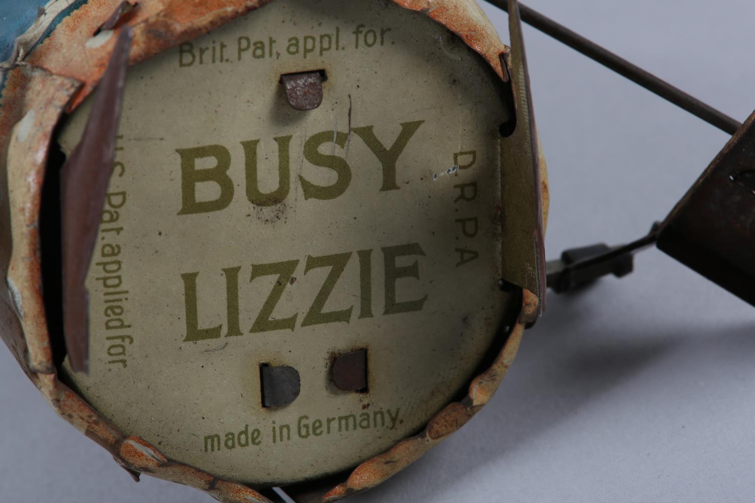 A GERMAN TIN PLATE CLOCK WORK BUSY LIZZIE, with key, 17.5cm high, printed name to underside - Image 2 of 5