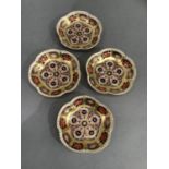 A set of four Royal Crown Derby pattern 1128 circular pin trays 11.5cm wide