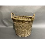 A large two handled wicker basket