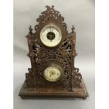 An Edwardian clock-barometer by the British United Clock Co in fretted and pierced boxwood case on a