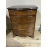 A small mahogany bow front chest of four graduated drawers, ring handles and on spade bracket feet