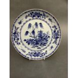 An early 19th century Chinese blue and white saucer dish painted to the centre with a willow tree
