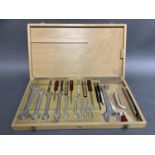 A German Saltus wooden tool case fitted with spanners in graduated sizes, screwdrivers, socket