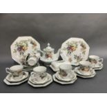 A pottery tea service printed with fruit comprising eight cups, eight saucers, eight teaplates, pair