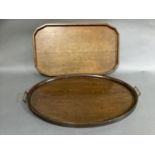 An oak oval and twin brass handled tray together with an oak tray with gallery and finger grips to