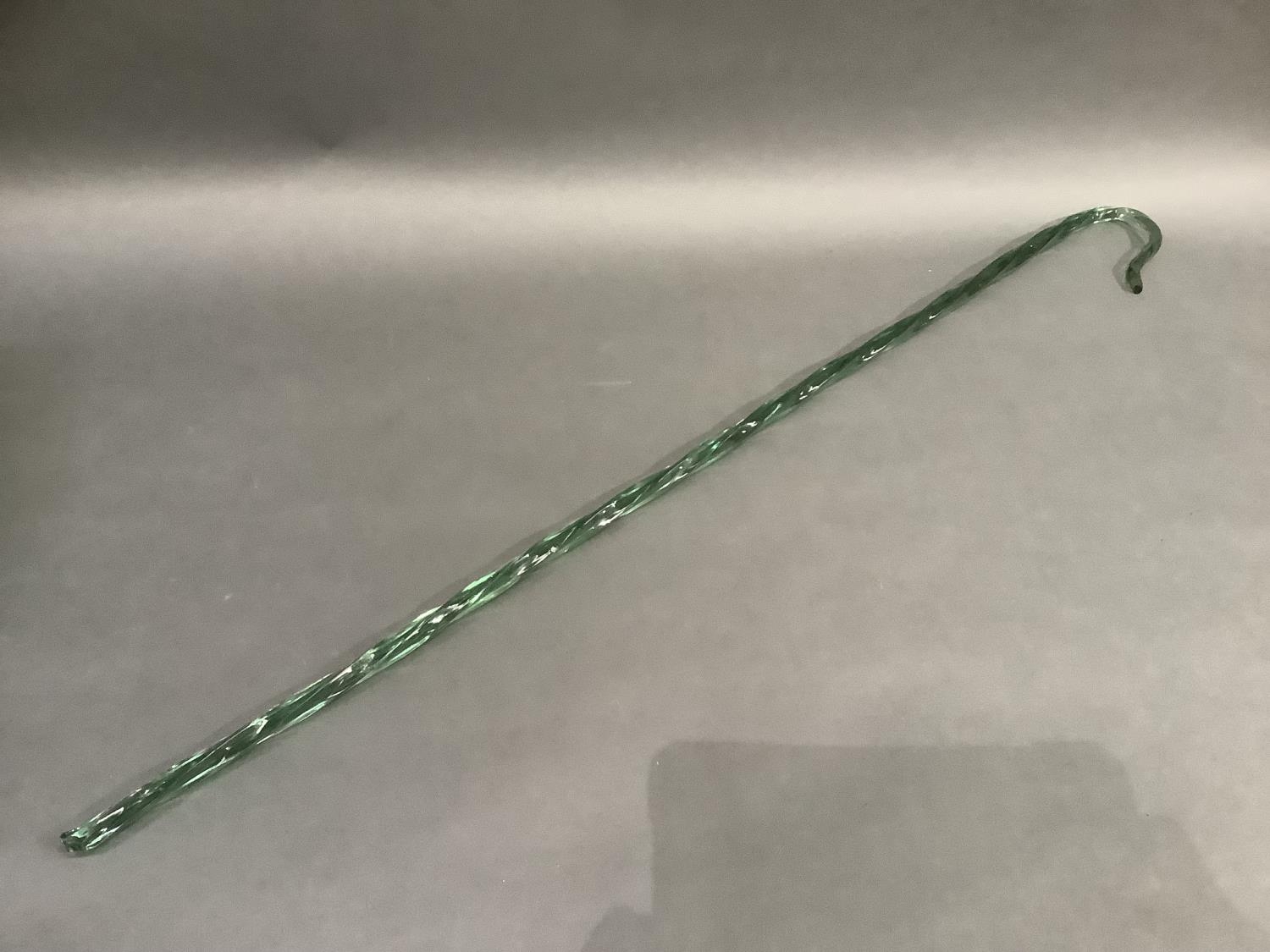 A 19th century Nailsea type green wrythern glass walking cane, 107cm long