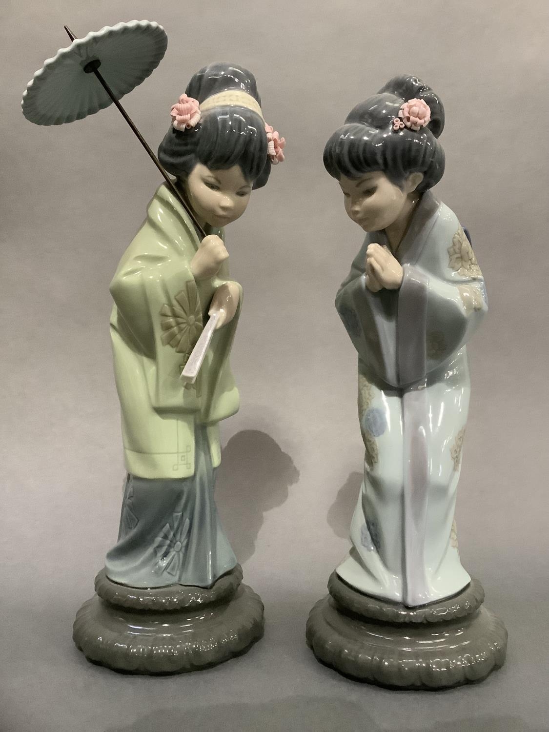 Two Lladro geishas, one with umbrella, 30cm and 27cm high