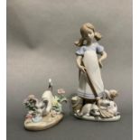 A Lladro figure group of girl wearing an apron with her mop and bucket and playful kittens, 21.5cm