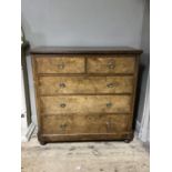 A late Victorian walnut chest of two short and three long drawers with rosette and ring handles