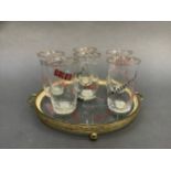 A 1950s glass and gilt metal drinks tray and six matching glasses