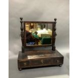 A 19th century mahogany toilet mirror having a rectangular glass, turned and square uprights, the