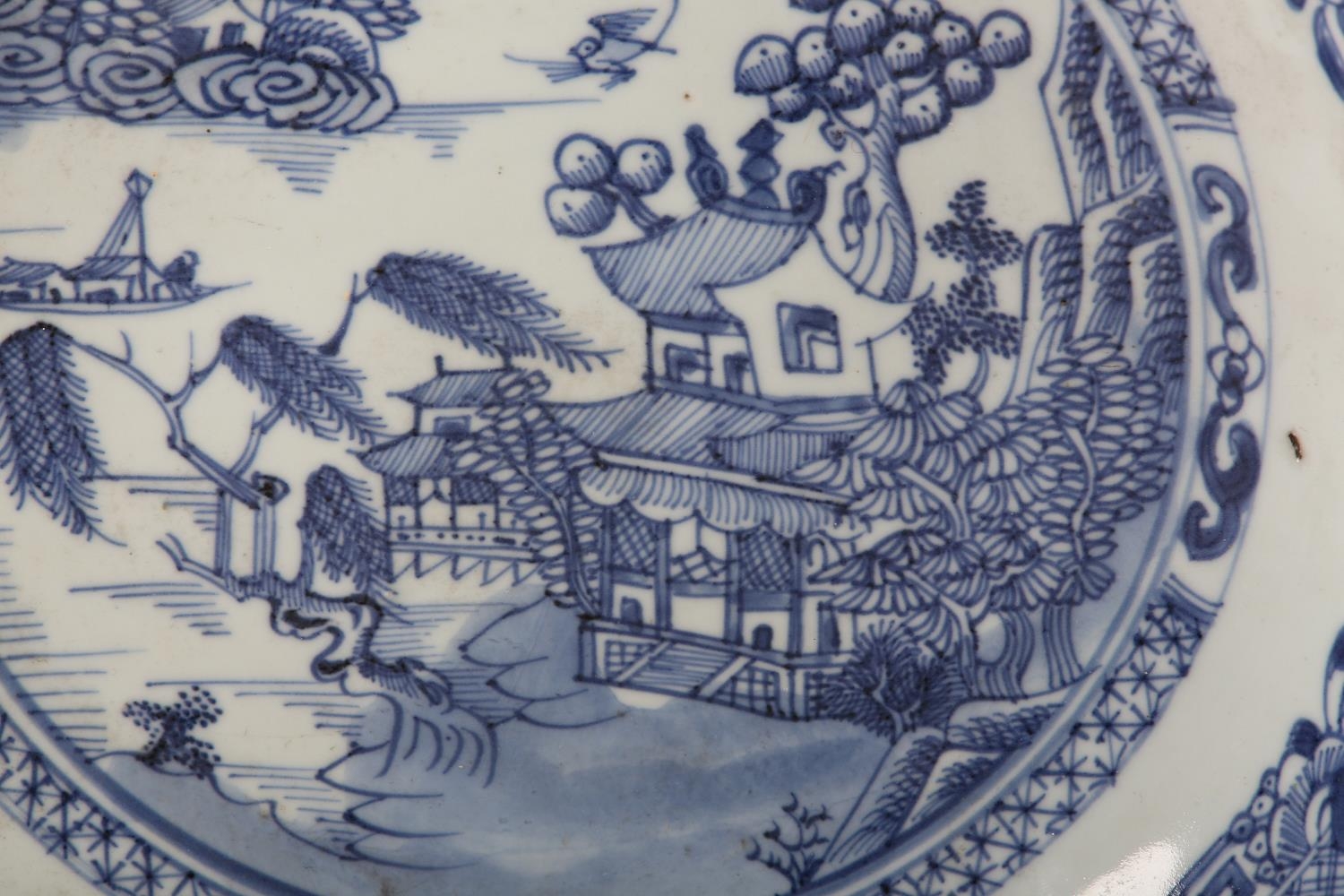 A Chinese blue and white saucer dish painted with pagoda, pine tree and willow tree in a river and - Image 2 of 3