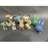 A collection of Sylvac and Melba ware pottery including two pairs of dogs, graduated size, and a