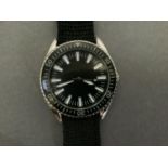 A 1960's style wristwatch in a chromed case, quartz movement, black dial with white batons and