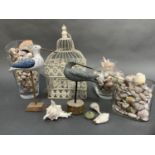 A large collection of sea shells, two wooden models of birds and a cream wirework birdcage