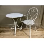A white painted wrought iron garden table and chair