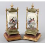 A pair of 19th century gilded brass and ceramic clock garnitures of urn shape printed and