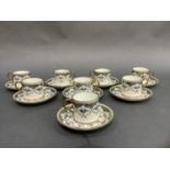 Eight English china coffee cans and saucers, enamelled in turquoise and painted with flowers and