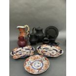 Items of black basalt including two coffee pots, sugar and cream, helmet shaped cream jug, plate,