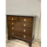 A mahogany crossbanded chest of two short and three long drawers with brass pendant handles and