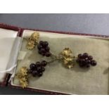 A garnet bead pendant and earring suite in 9ct gold, the graduated almandine beads set as grapes