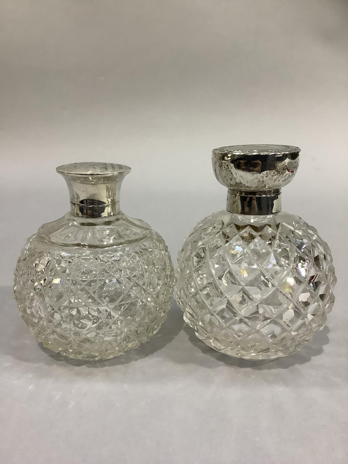 TWO GLOBULAR DIAMOND CUT GLASS SCENT BOTTLES with silver collars and hinged tops, Birmingham 1913