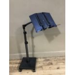 A music stand on adjustable pedestal and casters