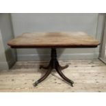 A 19th century mahogany rectangular breakfast tilt top table, turned pedestal and on quadruple